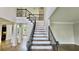 Elegant entryway with soaring ceilings, hardwood floors, iron-railed staircase and classic architectural details at 838 Natchez Valley Trce, Grayson, GA 30017