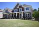 Elegant two-story home with stone and brick exterior, enhanced by lush lawn and beautiful architectural details at 838 Natchez Valley Trce, Grayson, GA 30017
