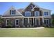 Beautiful two-story home featuring stone and brick accents, paired with well-maintained landscaping and a welcoming front yard at 838 Natchez Valley Trce, Grayson, GA 30017