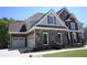 Charming home with stone and brick accents, featuring an attached garage and well-maintained landscaping at 838 Natchez Valley Trce, Grayson, GA 30017