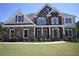 Inviting two-story home boasts stone and brick facade, complemented by manicured landscaping and a charming entrance at 838 Natchez Valley Trce, Grayson, GA 30017