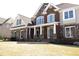 Striking two-story home with stone and brick facade, complemented by manicured landscaping and a well-kept front yard at 838 Natchez Valley Trce, Grayson, GA 30017