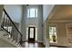 Grand foyer with hardwood floors, high ceilings, and decorative staircase at 838 Natchez Valley Trce, Grayson, GA 30017