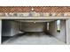 Spacious two-car garage with concrete floor and brick exterior at 838 Natchez Valley Trce, Grayson, GA 30017