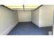 Clean, empty garage space with epoxy flooring and functional overhead door at 838 Natchez Valley Trce, Grayson, GA 30017