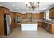 Gorgeous kitchen with wood cabinets, an island and stainless steel appliances at 838 Natchez Valley Trce, Grayson, GA 30017