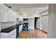 Modern kitchen featuring white cabinets, dark countertops, and stainless steel appliances at 838 Natchez Valley Trce, Grayson, GA 30017