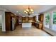 Spacious kitchen with rich wood cabinetry, a center island, and stainless steel appliances at 838 Natchez Valley Trce, Grayson, GA 30017
