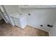 Clean laundry area with white cabinets, utility sink, and practical layout at 838 Natchez Valley Trce, Grayson, GA 30017