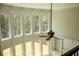 Sunlit living room with floor-to-ceiling windows and a stylish ceiling fan at 838 Natchez Valley Trce, Grayson, GA 30017