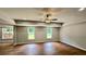 Spacious living room with recessed lighting, ceiling fan, and large windows overlooking backyard at 838 Natchez Valley Trce, Grayson, GA 30017