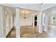 Spacious living room with hardwood floors, architectural columns and multiple windows with natural light at 838 Natchez Valley Trce, Grayson, GA 30017