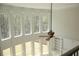Sun-filled living room with high ceilings, large windows overlooking the backyard and a modern ceiling fan at 838 Natchez Valley Trce, Grayson, GA 30017