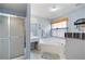 Modern bathroom featuring a glass enclosed shower, tub, and white fixtures at 2000 Spicers Ln, Woodstock, GA 30189