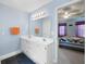 Bright bathroom features a double sink vanity with white cabinets and a large mirror at 2000 Spicers Ln, Woodstock, GA 30189
