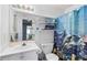 Cozy bathroom featuring a single sink vanity, toilet and a shower with blue patterned curtains at 2000 Spicers Ln, Woodstock, GA 30189