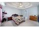 A cozy main bedroom with ample natural light, a ceiling fan, and comfortable furniture at 2000 Spicers Ln, Woodstock, GA 30189