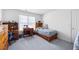 Bedroom with matching furnishings, desk, and comfortable bed, brightened by a large window at 2000 Spicers Ln, Woodstock, GA 30189