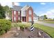 Lovely two-story brick home with manicured lawn, charming lighthouse statue and attached garage at 2000 Spicers Ln, Woodstock, GA 30189
