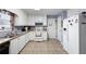 Well-lit kitchen featuring white cabinetry, laminate counters, and appliances at 2000 Spicers Ln, Woodstock, GA 30189