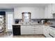 A kitchen showcasing bright white cabinetry, laminate counters, and stainless sink at 2000 Spicers Ln, Woodstock, GA 30189