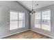 Bright breakfast nook featuring wood floors, neutral walls, and natural light from two large windows at 283 Double Gate Way, Sugar Hill, GA 30518