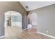 Open living space highlighting archways, wood floors, and staircase at 283 Double Gate Way, Sugar Hill, GA 30518