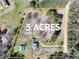 Aerial view of the estate showcasing the house, outbuildings, and expansive five-acre lot at 3121 Cox Cemetery Rd, Social Circle, GA 30025