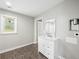 Bathroom vanity with storage, mirror, tiled floors, and a view of backyard through the window at 3121 Cox Cemetery Rd, Social Circle, GA 30025