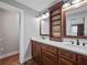 Nicely appointed bathroom featuring a double vanity, wood cabinets, and doorway to another room at 3121 Cox Cemetery Rd, Social Circle, GA 30025
