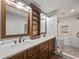 Modern bathroom boasting double sinks, granite countertops, tiled shower with glass door, and dark wood cabinets at 3121 Cox Cemetery Rd, Social Circle, GA 30025