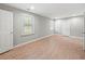 Bright, empty bedroom with wood-look floors, multiple windows, and neutral walls at 3121 Cox Cemetery Rd, Social Circle, GA 30025