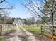 Exterior view of the white home with dormer windows and a long driveway at 3121 Cox Cemetery Rd, Social Circle, GA 30025
