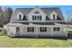Beautiful two-story home featuring a covered front porch and a manicured lawn, perfect for relaxing and entertaining at 3121 Cox Cemetery Rd, Social Circle, GA 30025
