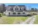 Charming two-story home with a covered front porch, a long driveway, and ample green space for outdoor activities at 3121 Cox Cemetery Rd, Social Circle, GA 30025