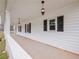 Inviting front porch with classic lighting, offering a perfect spot to relax and enjoy the outdoors at 3121 Cox Cemetery Rd, Social Circle, GA 30025