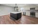 Well-lit kitchen features white cabinets, stainless steel appliances, a herringbone backsplash, and a black island with white countertop at 3121 Cox Cemetery Rd, Social Circle, GA 30025