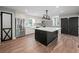 Modern kitchen featuring an island, stainless steel appliances, and ample cabinet space for culinary enthusiasts at 3121 Cox Cemetery Rd, Social Circle, GA 30025