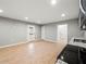 Bright kitchen area with modern appliances, wood-look flooring, and a door leading to outdoor space at 3121 Cox Cemetery Rd, Social Circle, GA 30025