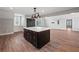 Kitchen island featuring dark wood cabinets, white countertops, and stainless hardware in an open floor plan at 3121 Cox Cemetery Rd, Social Circle, GA 30025