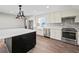 Bright kitchen features stainless appliances, white cabinets, a center island with a white countertop, and herringbone backsplash at 3121 Cox Cemetery Rd, Social Circle, GA 30025