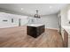Kitchen island featuring dark wood cabinets, white countertops, and stainless hardware in an open floor plan at 3121 Cox Cemetery Rd, Social Circle, GA 30025