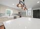 Spacious kitchen with shaker cabinets, herringbone backsplash, stainless appliances, and a large island with a white countertop at 3121 Cox Cemetery Rd, Social Circle, GA 30025