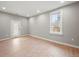 Inviting living room with natural light, wood-look floors, and neutral color scheme at 3121 Cox Cemetery Rd, Social Circle, GA 30025