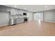 Spacious living room features wood-style floors, stainless steel appliances, and grey cabinets at 3121 Cox Cemetery Rd, Social Circle, GA 30025