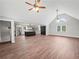 Spacious living room with vaulted ceilings and hardwood floors, seamlessly connecting to the kitchen and dining area at 3121 Cox Cemetery Rd, Social Circle, GA 30025