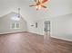 Open-concept living room with vaulted ceilings and hardwood floors leading to hallway at 3121 Cox Cemetery Rd, Social Circle, GA 30025