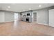 Open living room with tile flooring, kitchen area with stainless steel appliances, and entry way at 3121 Cox Cemetery Rd, Social Circle, GA 30025