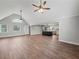 Open-concept living room with vaulted ceilings, hardwood floors, and kitchen with a central island at 3121 Cox Cemetery Rd, Social Circle, GA 30025