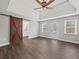 Spacious main bedroom with dark wood floors, tray ceiling, sliding barn door and lots of natural light at 3121 Cox Cemetery Rd, Social Circle, GA 30025